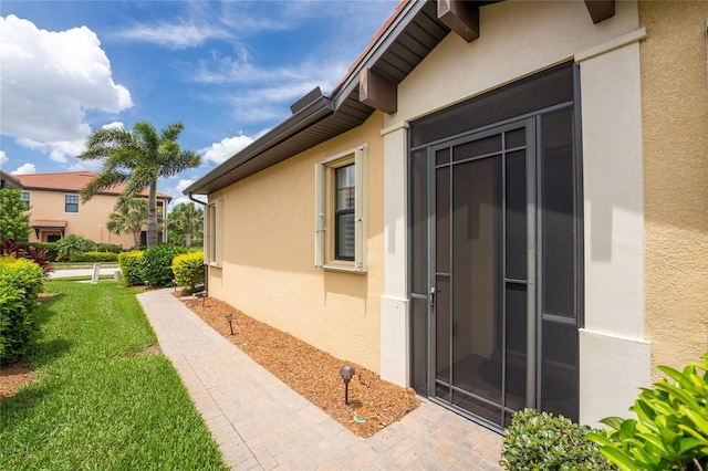 view of side of property with a yard