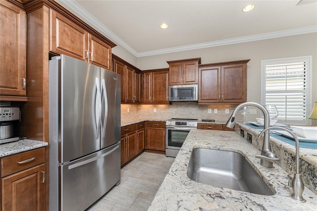 kitchen featuring sink, stainless steel appliances, tasteful backsplash, light stone counters, and crown molding