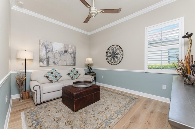 living room with hardwood / wood-style flooring, ceiling fan, and ornamental molding