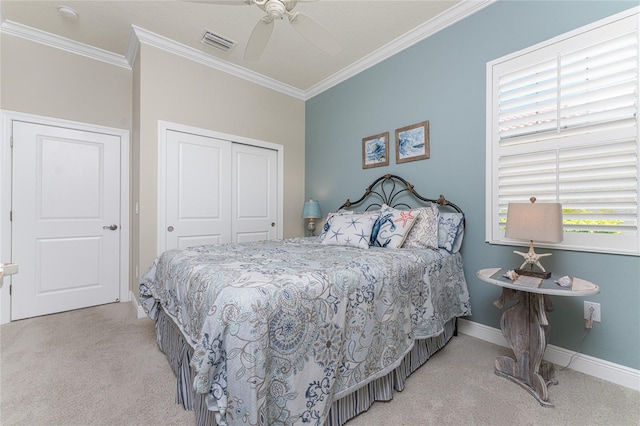 bedroom with ceiling fan, a closet, crown molding, and light carpet