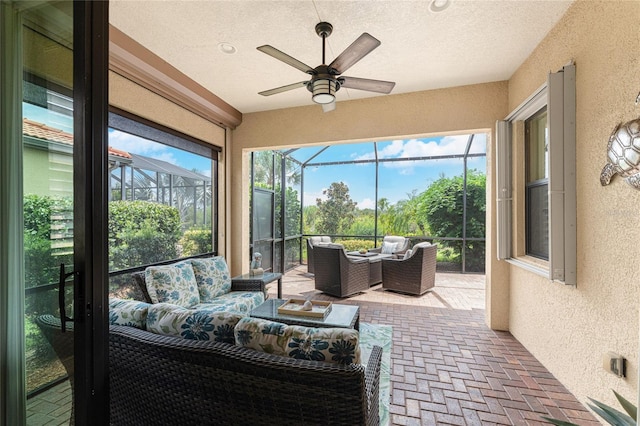 sunroom featuring ceiling fan