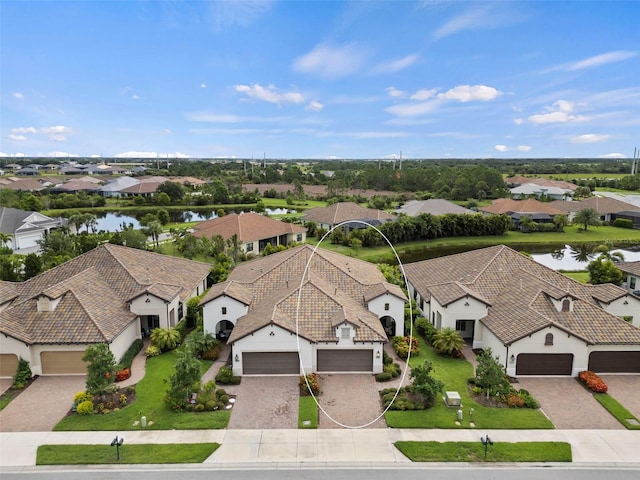 birds eye view of property featuring a residential view and a water view