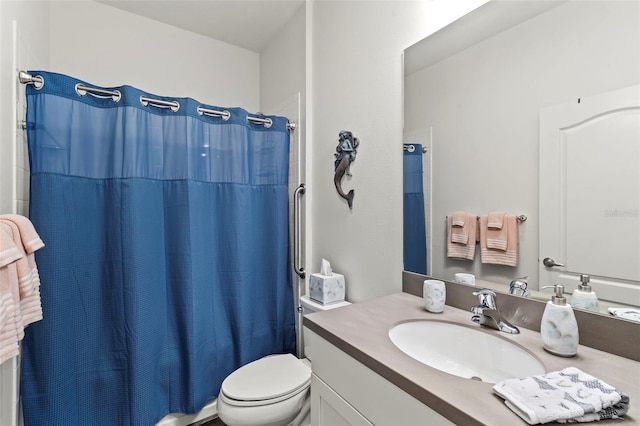 bathroom featuring a shower with shower curtain, toilet, and vanity