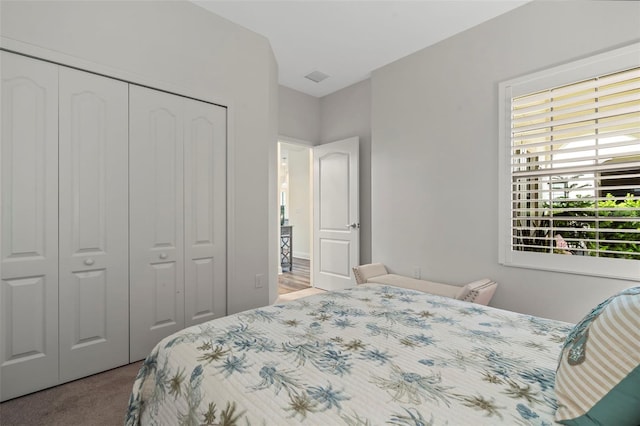 bedroom featuring light carpet and a closet