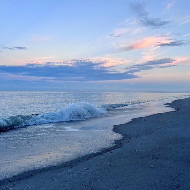 property view of water featuring a beach view