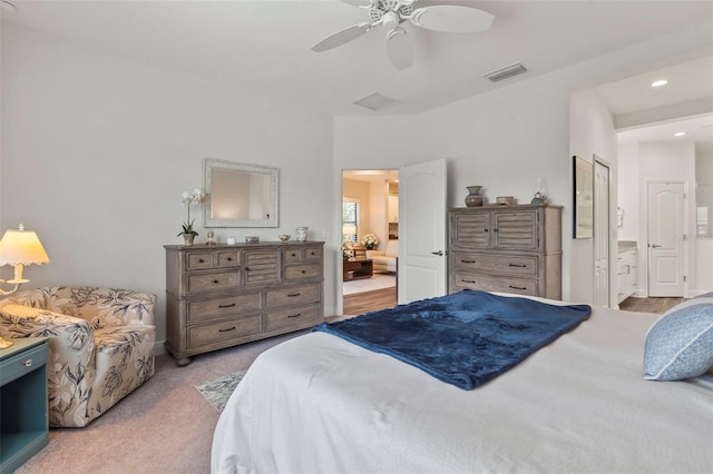 carpeted bedroom featuring ensuite bathroom and ceiling fan