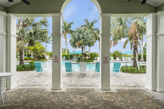 pool with a patio area and a ceiling fan