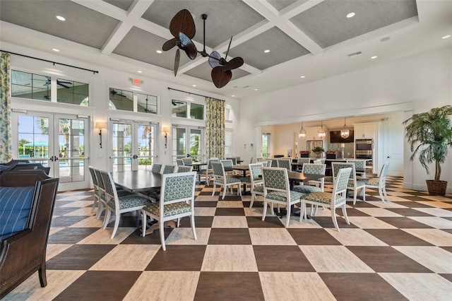 dining area with recessed lighting, french doors, coffered ceiling, and a towering ceiling