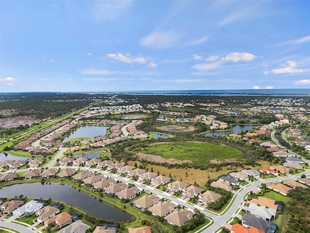 drone / aerial view featuring a water view and a residential view