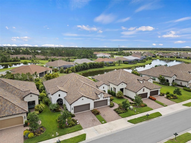 drone / aerial view with a residential view and a water view