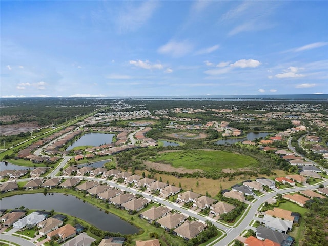 bird's eye view featuring a water view and a residential view