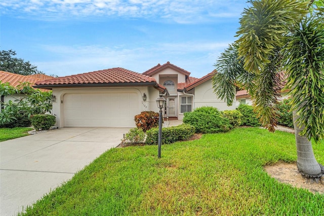 mediterranean / spanish home featuring a front lawn and a garage