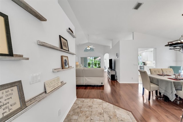 interior space featuring light hardwood / wood-style floors and vaulted ceiling