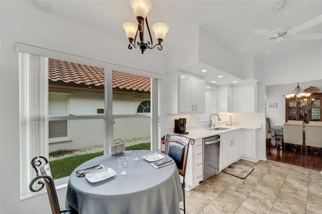 kitchen with white cabinets, ceiling fan with notable chandelier, sink, stainless steel dishwasher, and decorative light fixtures