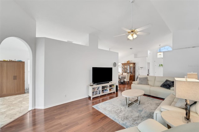 living room featuring ceiling fan, dark hardwood / wood-style flooring, and high vaulted ceiling