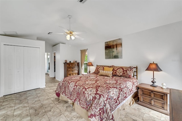 bedroom with ceiling fan, a closet, and lofted ceiling