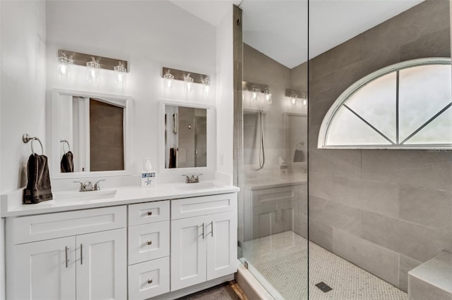 bathroom with vanity and tiled shower