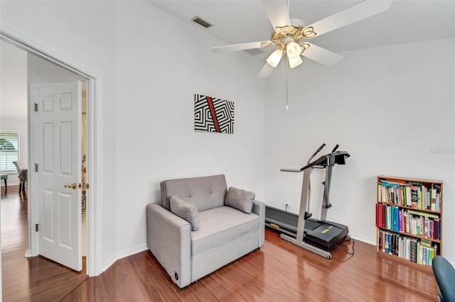 living area with ceiling fan and hardwood / wood-style flooring