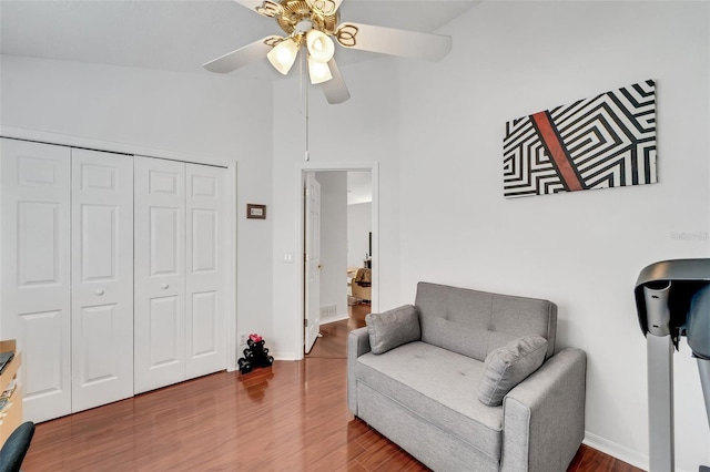 sitting room featuring hardwood / wood-style flooring, ceiling fan, and lofted ceiling