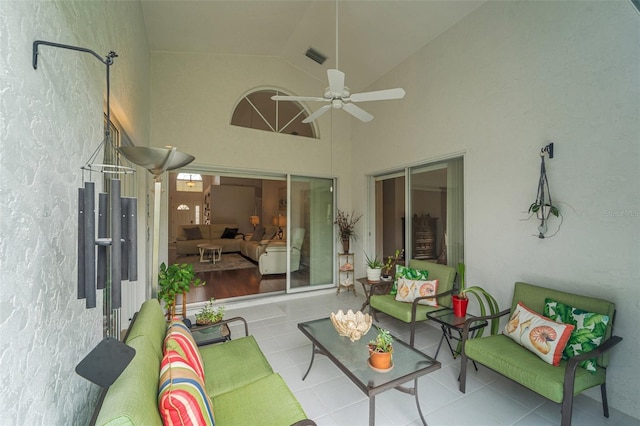 sunroom / solarium with ceiling fan and lofted ceiling