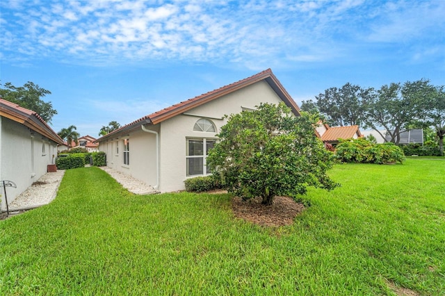 view of home's exterior with a yard