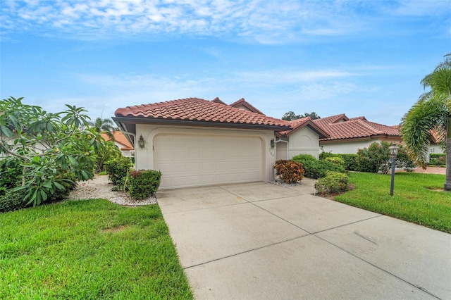 mediterranean / spanish home featuring a garage and a front lawn