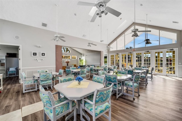 dining space featuring french doors, high vaulted ceiling, and wood-type flooring