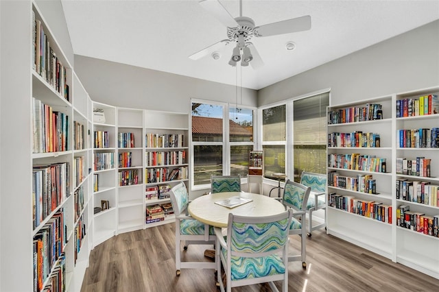 living area featuring hardwood / wood-style flooring and ceiling fan