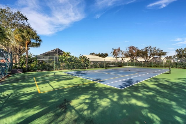 view of tennis court with basketball hoop