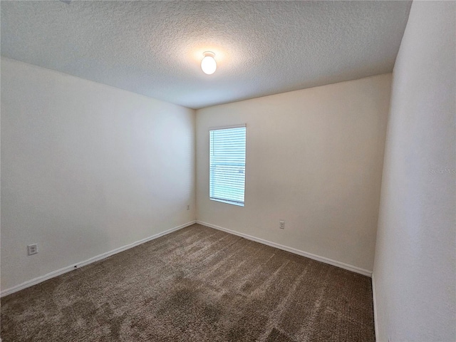 carpeted spare room featuring a textured ceiling