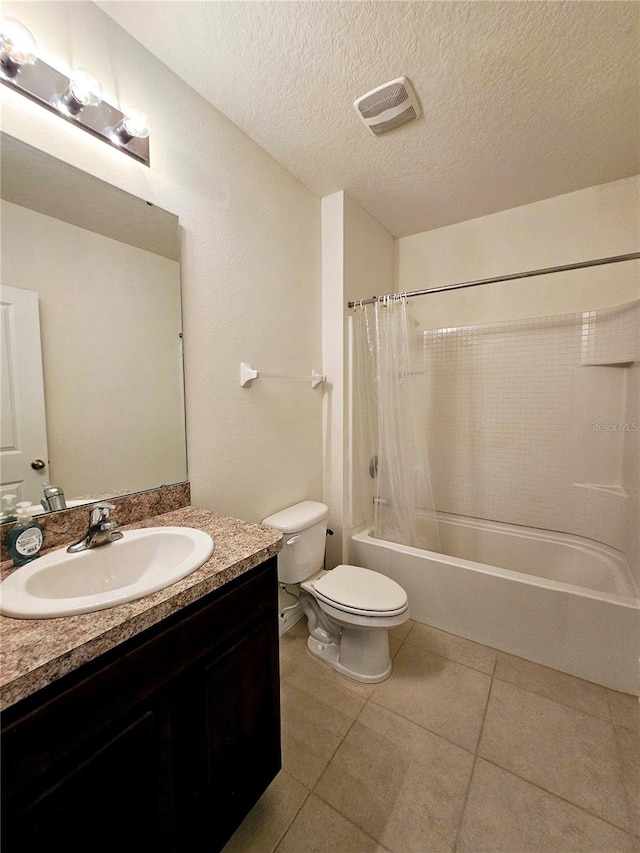 full bathroom with shower / bath combination with curtain, tile patterned floors, vanity, a textured ceiling, and toilet