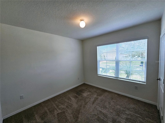 empty room with dark carpet