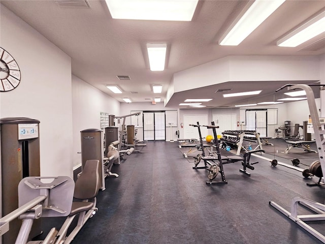 exercise room featuring a textured ceiling