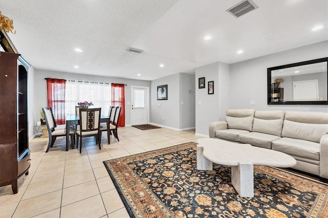 tiled living room with a textured ceiling