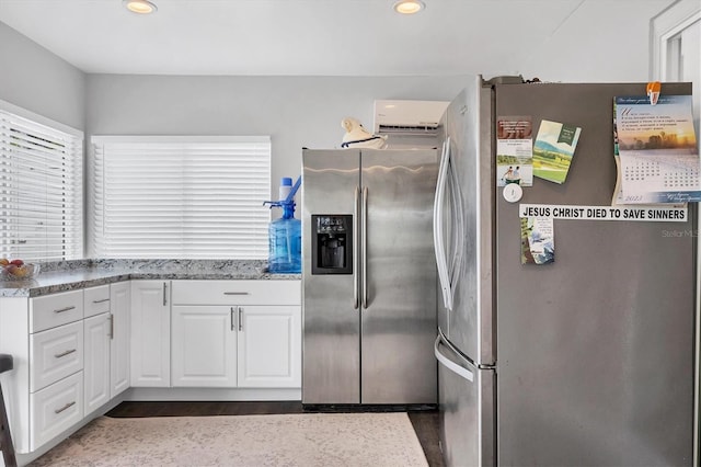 kitchen featuring dark wood-type flooring, white cabinets, light stone counters, stainless steel refrigerator, and stainless steel refrigerator with ice dispenser