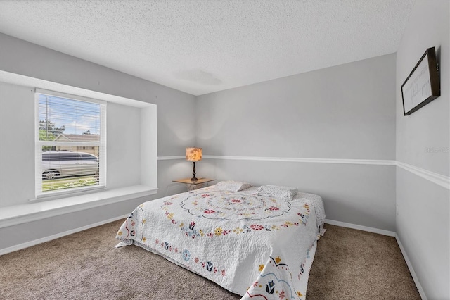 bedroom featuring a textured ceiling and carpet flooring