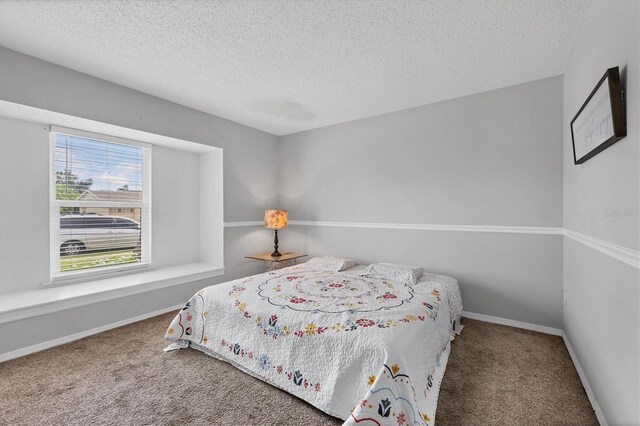 8509 La Boca Ave, North Port, FL 34287 - carpeted bedroom with a textured ceiling and baseboards