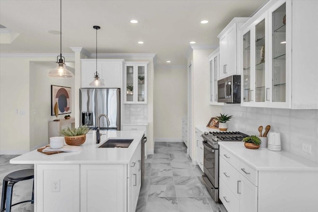 kitchen with pendant lighting, sink, white cabinetry, and stainless steel appliances