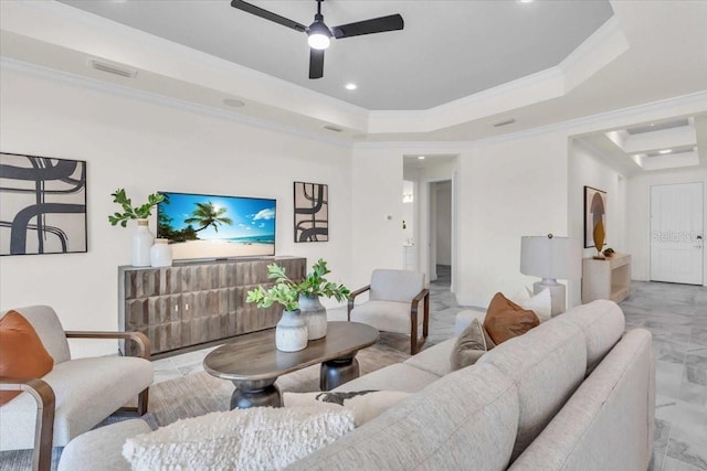 living room featuring a tray ceiling, ceiling fan, and crown molding