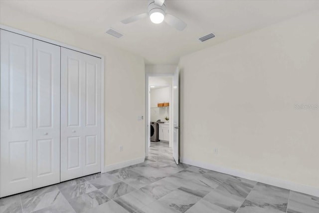 unfurnished bedroom featuring a closet, ceiling fan, and washing machine and clothes dryer