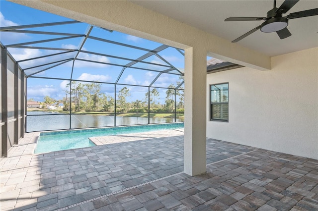 view of swimming pool featuring a lanai, ceiling fan, a water view, and a patio