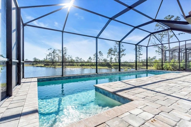 view of pool featuring a lanai, a patio area, and a water view