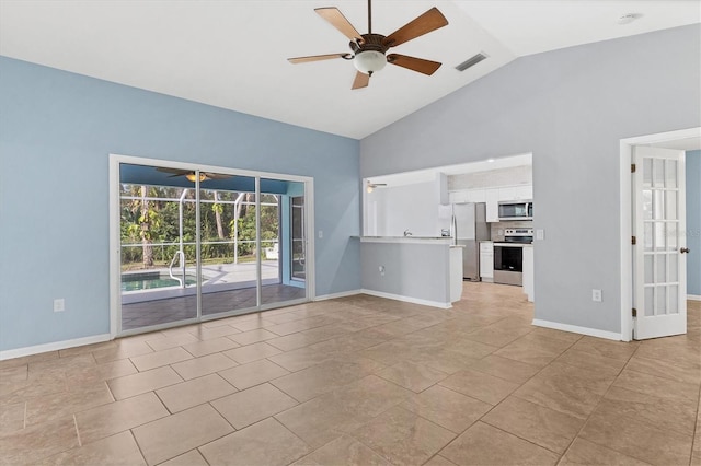 unfurnished living room with ceiling fan, light tile patterned flooring, and high vaulted ceiling