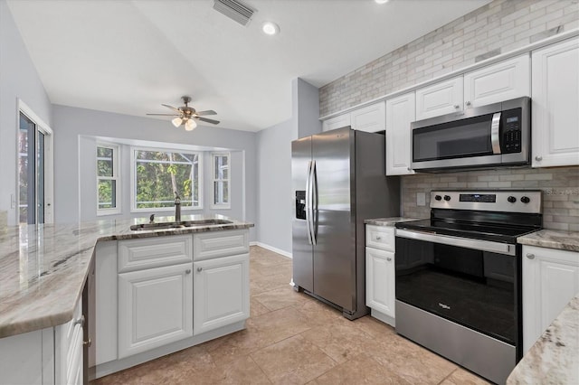 kitchen with ceiling fan, appliances with stainless steel finishes, sink, and white cabinetry