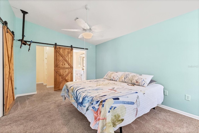 bedroom featuring ceiling fan, carpet, and a barn door