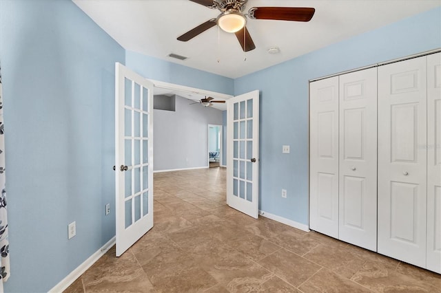 unfurnished bedroom featuring ceiling fan, a closet, and french doors