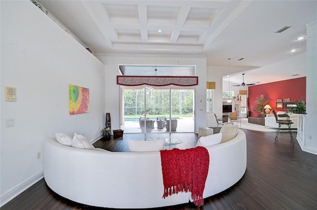 living room featuring ceiling fan, beamed ceiling, wood-type flooring, and coffered ceiling