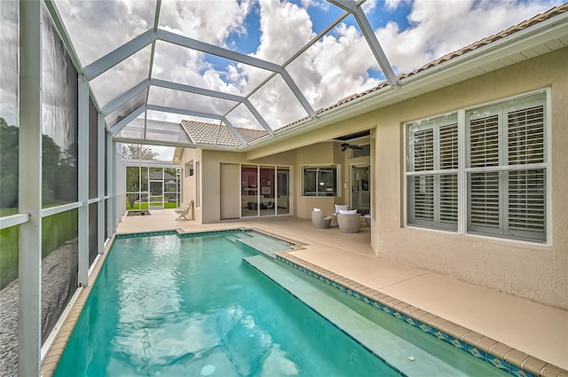 view of swimming pool with a lanai and a patio