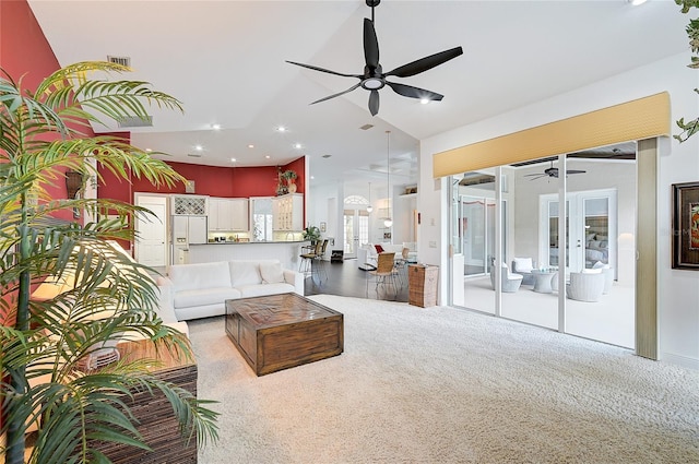 carpeted living room with ceiling fan