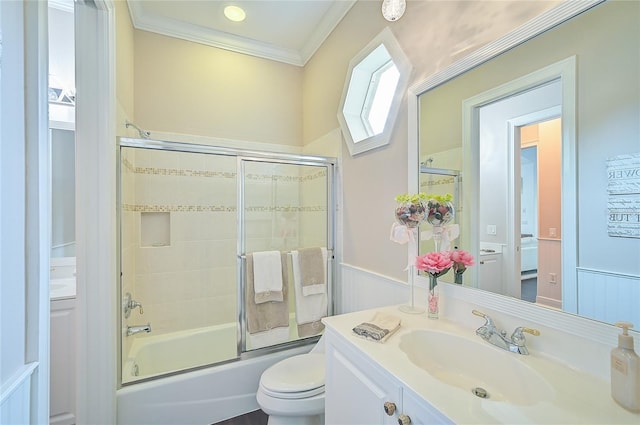 full bathroom featuring vanity, toilet, shower / bath combination with glass door, and crown molding